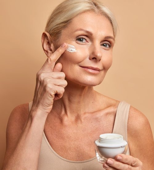 middle-aged-beautiful-woman-applies-anti-aging-cream-face-undergoes-beauty-treatments-cares-about-skin