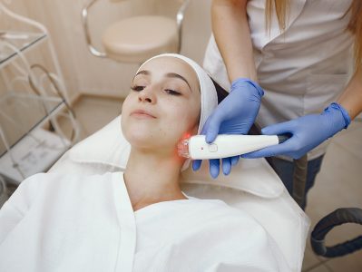 Cosmetologist use laser. Woman with cosmetologist. Lady in a beauty studio.